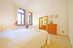 a bedroom with a large white bed and a window at DolceVita Apartments N 331 in Venice