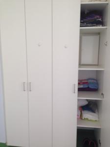 a white closet with white cabinets in a room at Wiesbaden Apartment in Wiesbaden