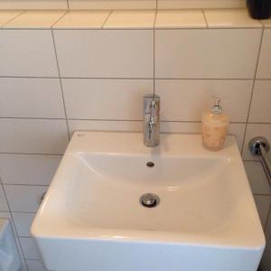 a white sink in a bathroom with a candle at Wiesbaden Apartment in Wiesbaden