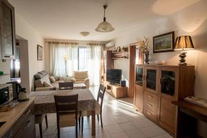 a kitchen and living room with a table and a couch at Cozy home in Petrovac na Moru
