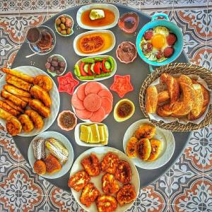 a table with plates of food on a table at Stone Hill Hotel in Ayvalık +35 photos