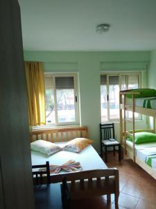 a bedroom with two bunk beds and a chair at The Green Apartment in Golem