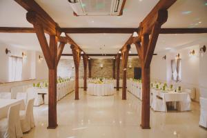 a banquet hall with white tables and chairs at Green Resort Glamping in Radlje ob Dravi