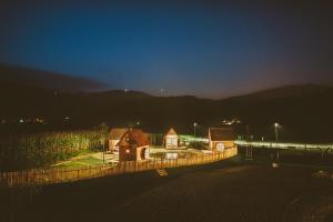 a group of buildings in a field at night at Green Resort Glamping in Radlje ob Dravi