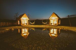 a reflection of a house in a pool of water at Green Resort Glamping in Radlje ob Dravi