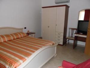 Giường trong phòng chung tại Hotel Coste Del Lago