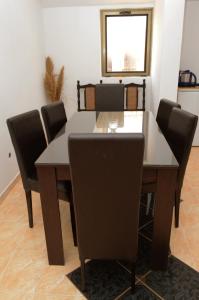 a dining room with a table and chairs at Guest House Lukac in Bar