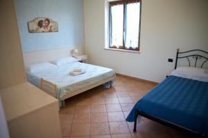 Postel nebo postele na pokoji v ubytování Agriturismo Albarello