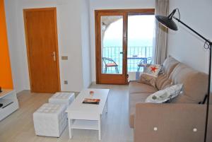 a living room with a couch and a table at Albatros House in L'Escala