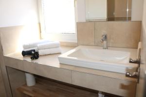 a bathroom with a sink and a mirror at City Home- Business Apartment in Nuremberg