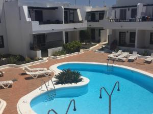 a large swimming pool in the middle of a building at Apartamento Albatros in Puerto del Carmen