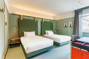 A bed or beds in a room at Room Mate Collection Giulia, Milan