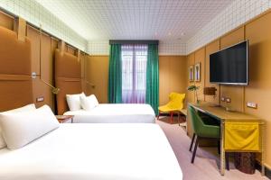 A bed or beds in a room at Room Mate Collection Giulia, Milan