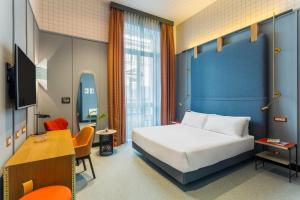 A bed or beds in a room at Room Mate Collection Giulia, Milan