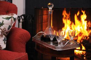 a tray with wine glasses in front of a fireplace at Hob Knob in Edgartown