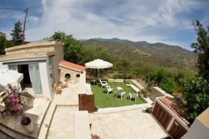 an aerial view of a house with a lawn with chairs at Vavla Nature House in Vavla