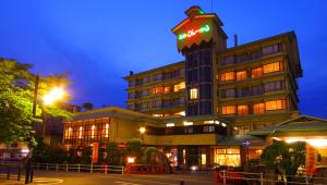 a hotel building with a sign on top of it at Isawa View Hotel in Fuefuki