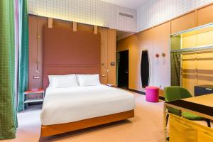 A bed or beds in a room at Room Mate Collection Giulia, Milan