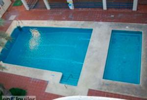 a swimming pool with blue water in a building at Azucena in Garrucha