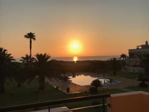 a sunset view from the balcony of a resort at Oliva Nova Casas del Mar in Oliva