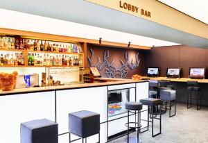 a bar at a loyalty bar with stools at Lucky Bansko Aparthotel SPA & Relax in Bansko