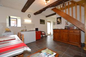 a kitchen with a table and a counter top at Chambres d'hôtes La Fontaine Garel in Iffendic