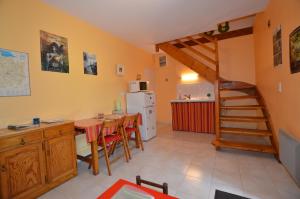 a kitchen with a table and a staircase in a room at Chambres d'hôtes La Fontaine Garel in Iffendic +29 photos