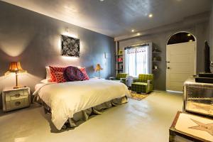 a bedroom with a large bed with red pillows at Jinhue Hotel in Luye