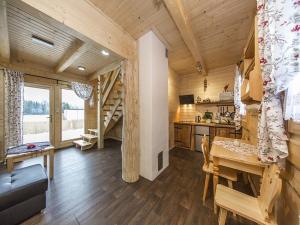 a living room with a dining room table and a kitchen at Domki nad Białką in Czarna Góra