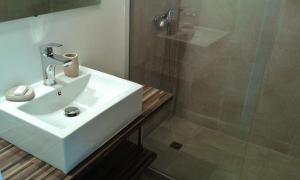 a bathroom with a white sink and a shower at Studio Sable Cannelle in Le Gosier +14 photos
