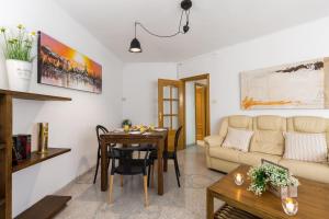 a living room with a table and a couch at Matarolux 9 in Mataró +15 photos