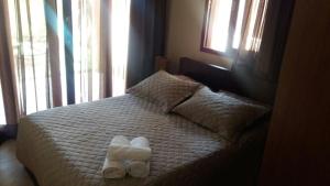 a bedroom with a bed with two towels on it at Suite Pipa Beleza Spa Resort in Pipa +54 photos