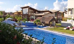 an image of a house with a swimming pool at Suite Pipa Beleza Spa Resort in Pipa