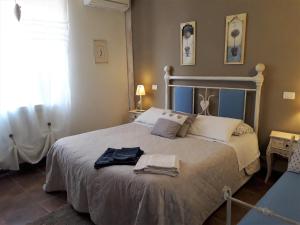 a bedroom with a large bed with towels on it at Agriturismo San Giacomo in Pitigliano