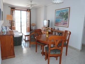 a living room with a wooden table and chairs at Shoal Apartamentos in Playas de Orihuela