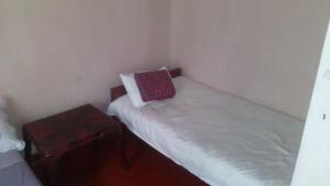 a small room with a bed with a pillow on it at Sembuwatta Reach Homestay in Elkaduwa