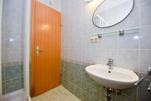a bathroom with a sink and a mirror at Milka Appartements in Stara Novalja +26 photos