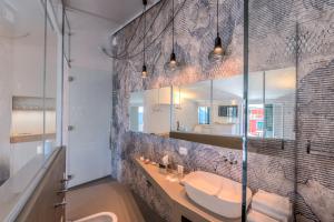 a bathroom with a sink and a mirror at La Vista di Marina by The First in Riomaggiore