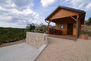a small house with a stone wall and a porch at Marina House in Drage +19 photos