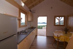 a kitchen with a sink and a table with a dining room at Marina House in Drage