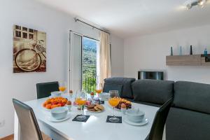 a dining room table with wine glasses and fruit on it at Town House Cas Decu in Fornalutx