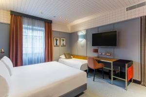 A bed or beds in a room at Room Mate Collection Giulia, Milan