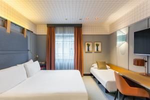 A bed or beds in a room at Room Mate Collection Giulia, Milan