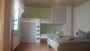 a room with a bed and a bunk bed at Ferienwohnung Stiem in Dankerode