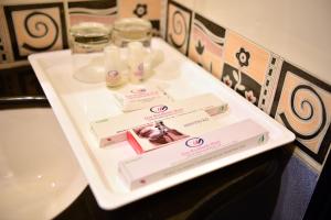 a white table with two bottles of soap and a sink at Goa Woodlands Hotel in Madgaon