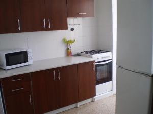 a kitchen with a white refrigerator and a microwave at Apartamento Cardenal Cisneros in Gandía