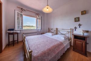 Postel nebo postele na pokoji v ubytování Agriturismo Quercetelli