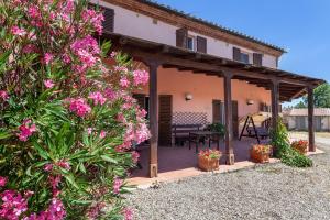 a patio of a house with pink flowers at Agriturismo Quercetelli in Castiglione del Lago