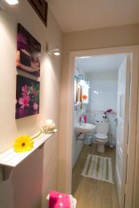 a bathroom with a white toilet and a sink and a sink at Apt El Perenquen in Santa Cruz de Tenerife