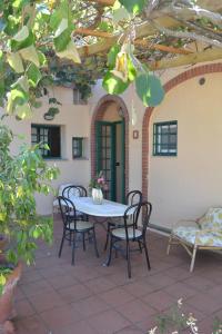 a table and chairs sitting on a patio at Turignano Apartment in Montespertoli